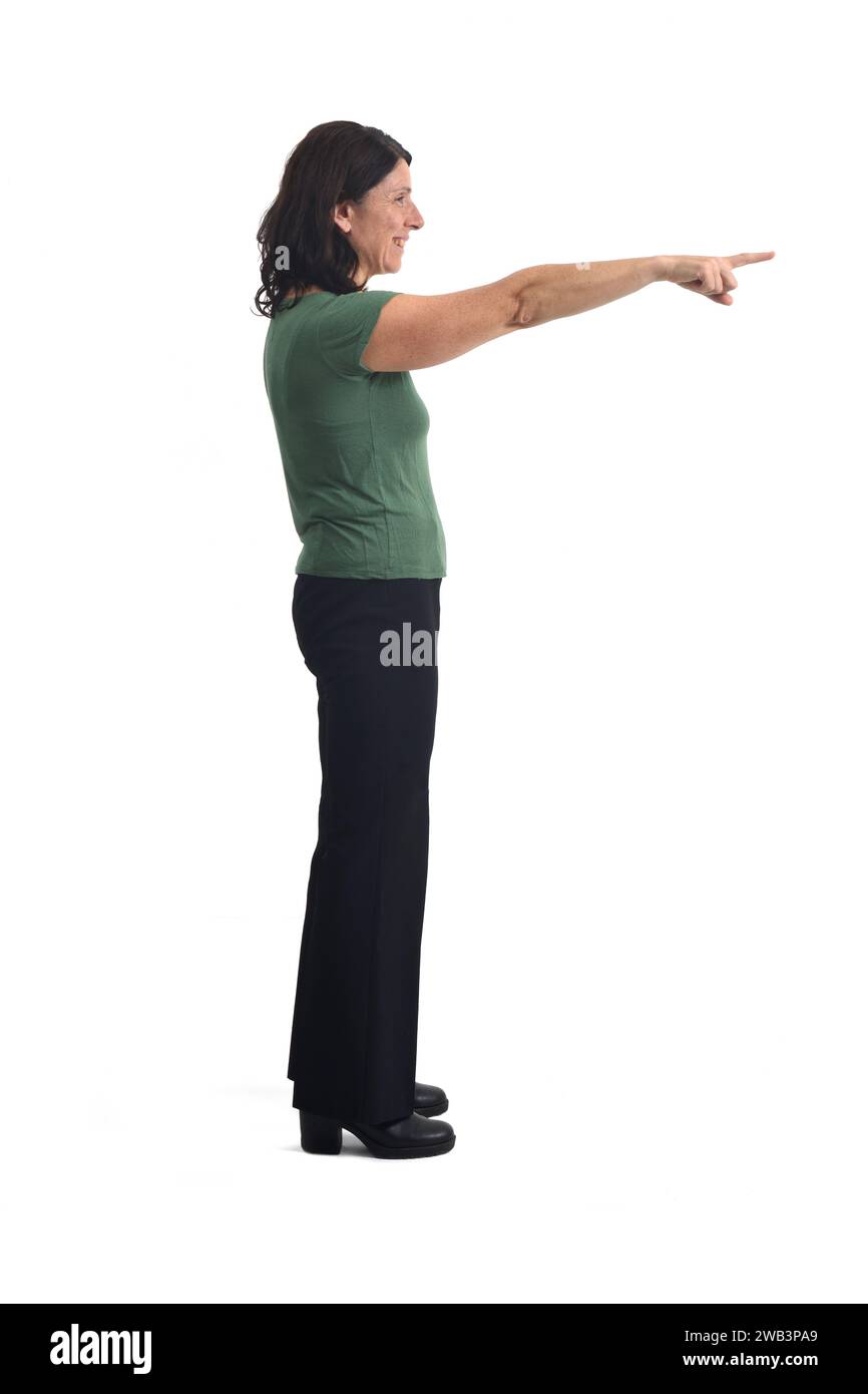 Side view of a woman pointing to the front on white background. Stock Photo