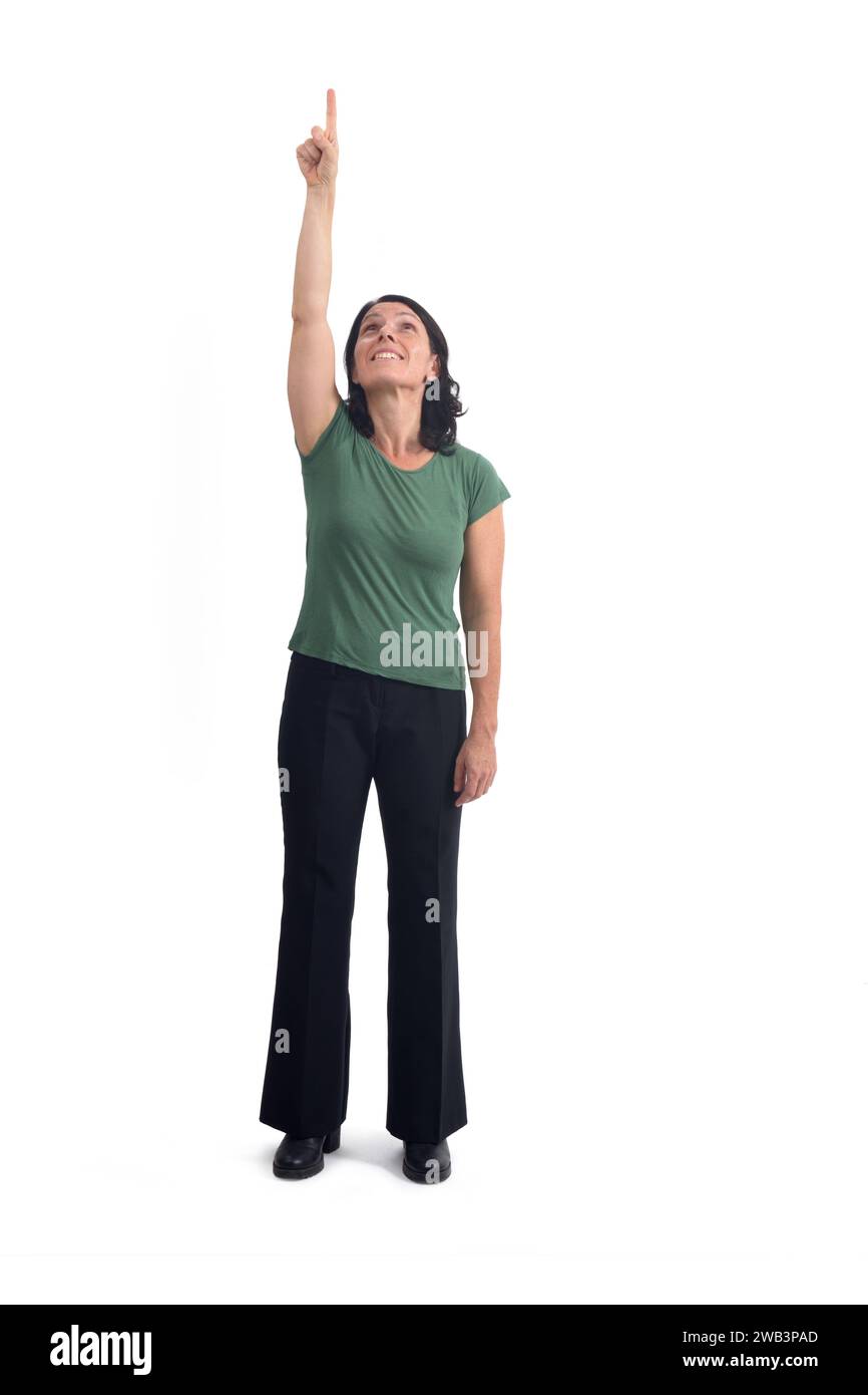 front view of a woman pointing up and looking up on white background Stock Photo
