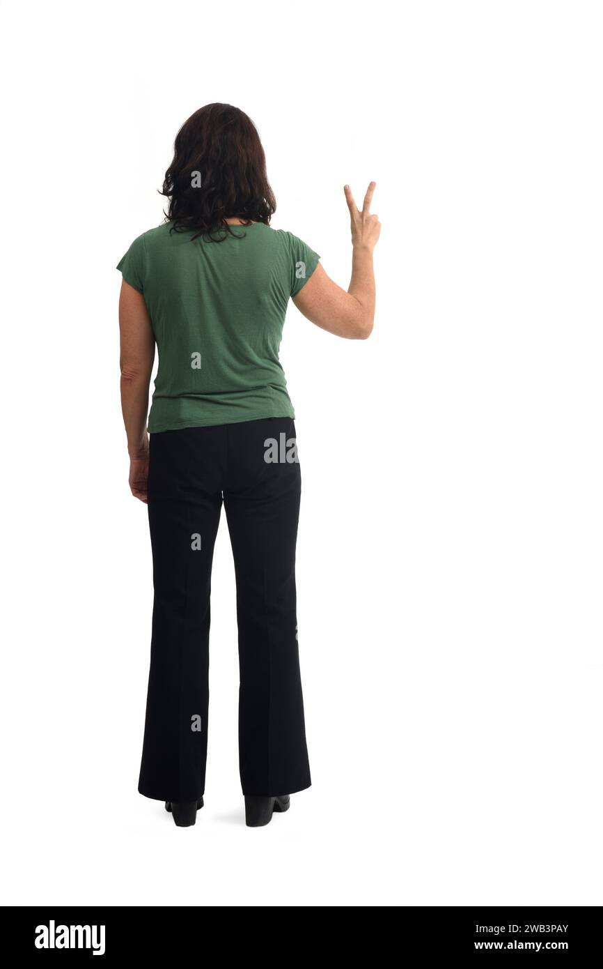 back view of a woman showing victory sign with fingers on white background Stock Photo