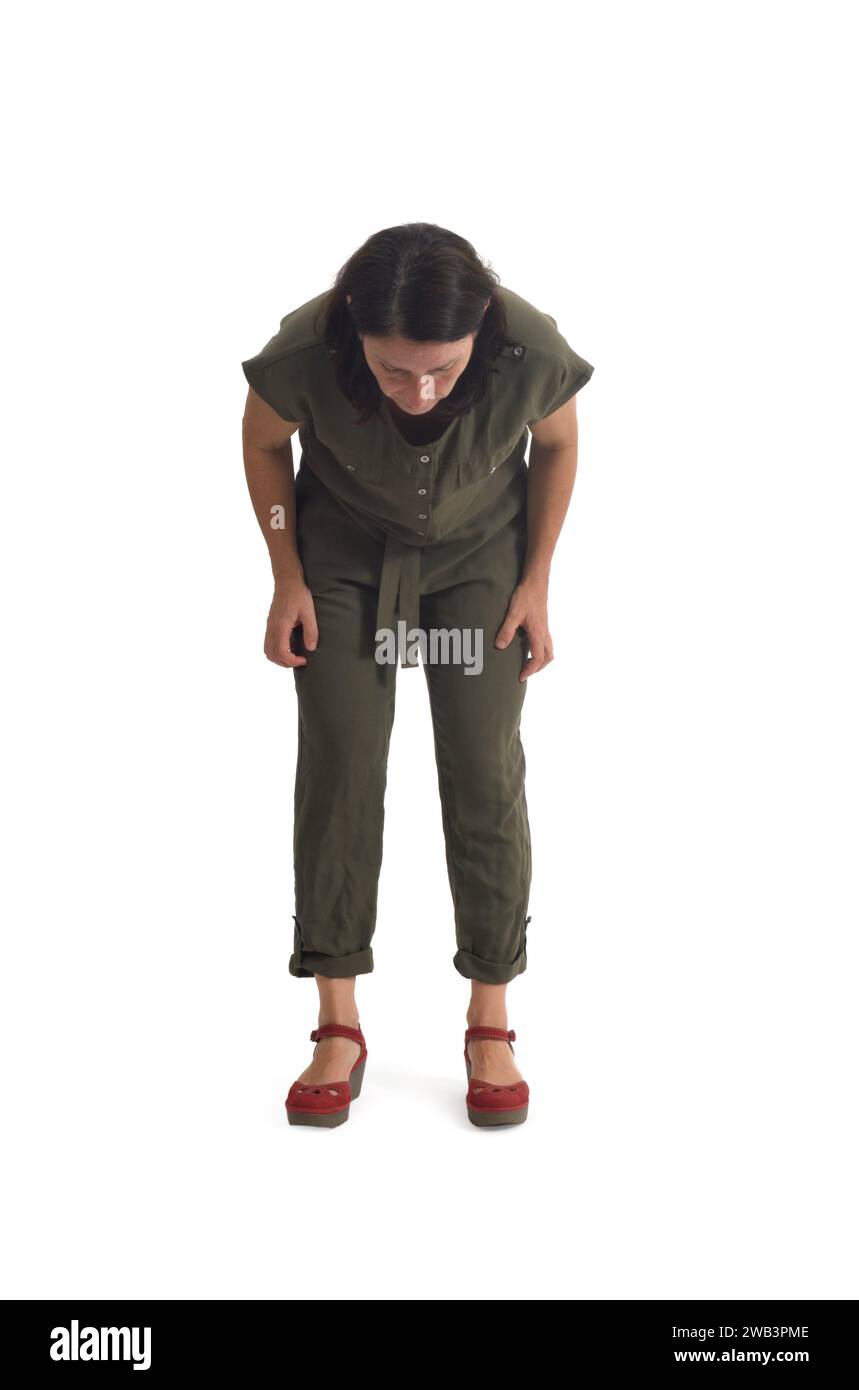 front view of a woman standing looking at the floor searching for something on white background. Stock Photo