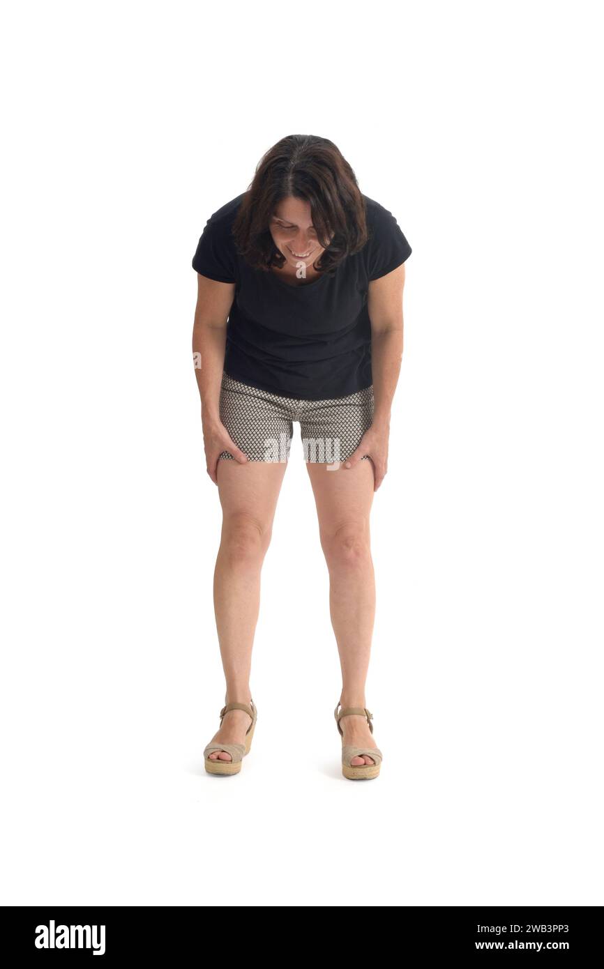 front view of a woman crouching and looking at the ground on white background Stock Photo