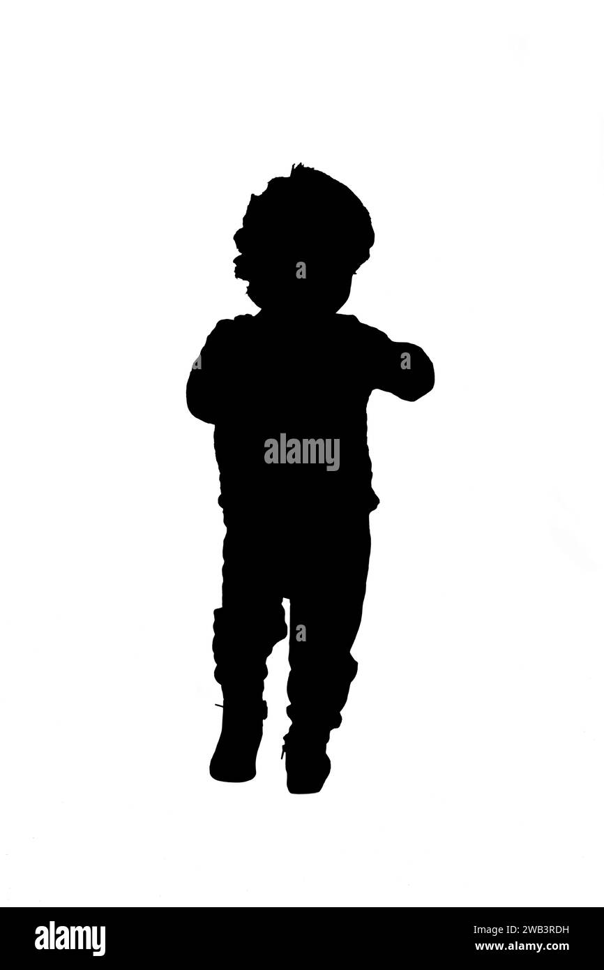 back view silhouette of a baby boy walking on white background Stock Photo