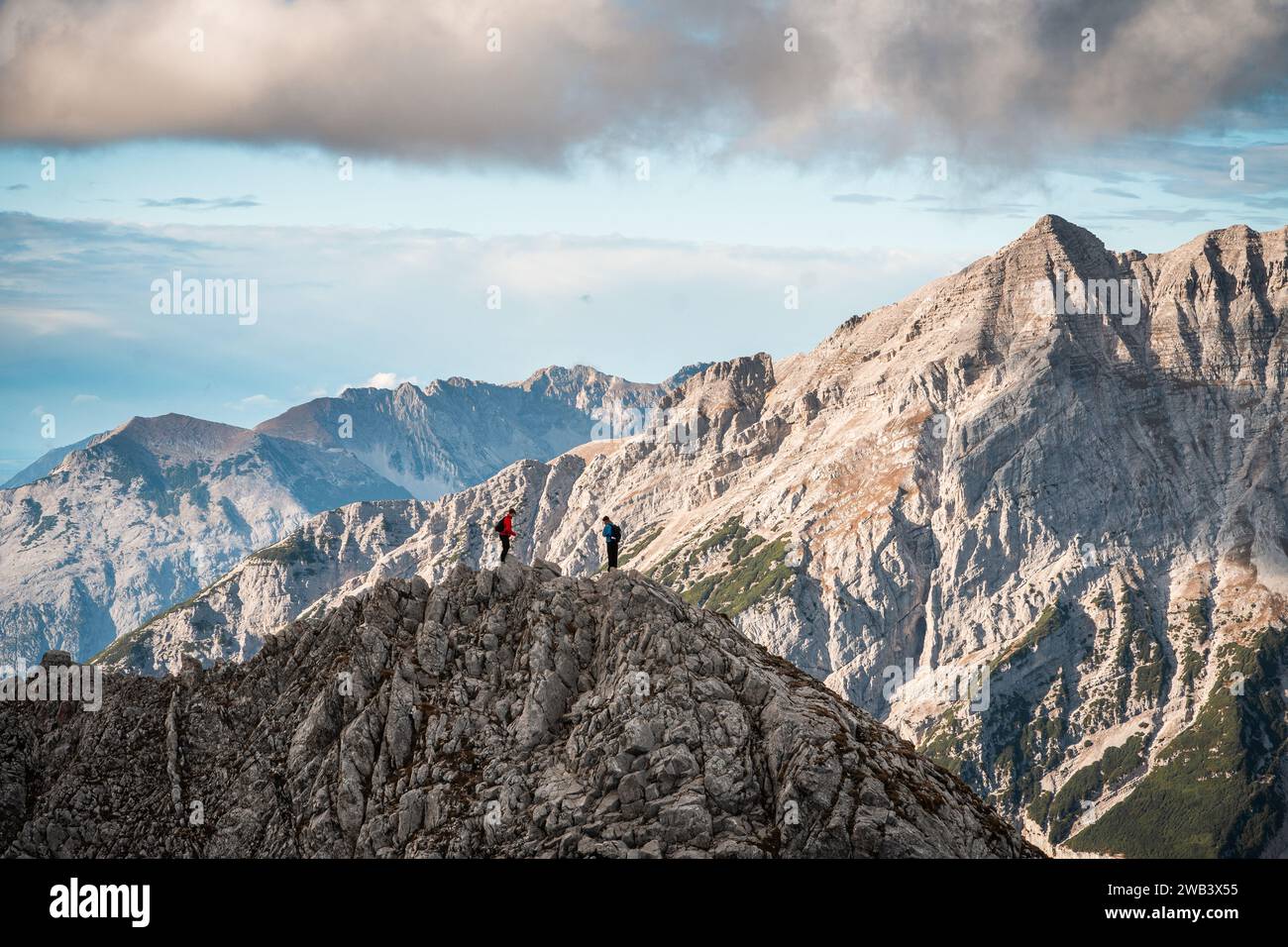 Landscape of two hikers standing on the top of the mountain after ...