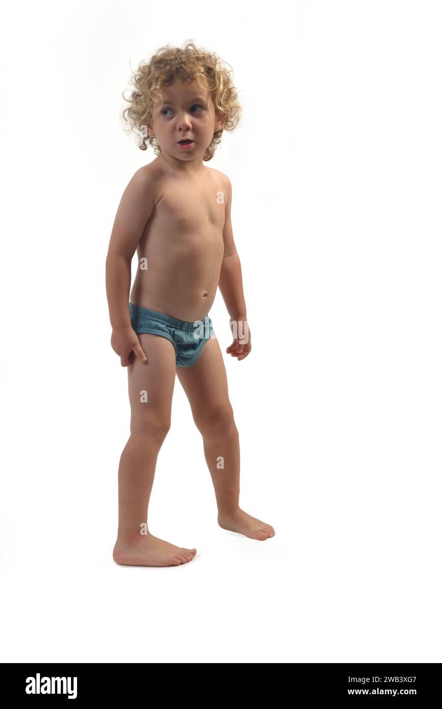 portrait of a boy in underpants looking away on white background (3 year old) Stock Photo