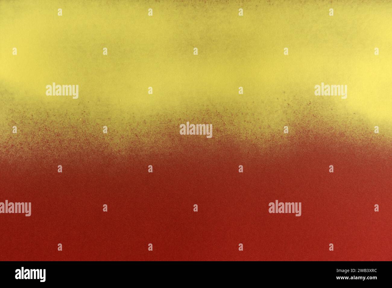 yellow spray paint on red paper background Stock Photo