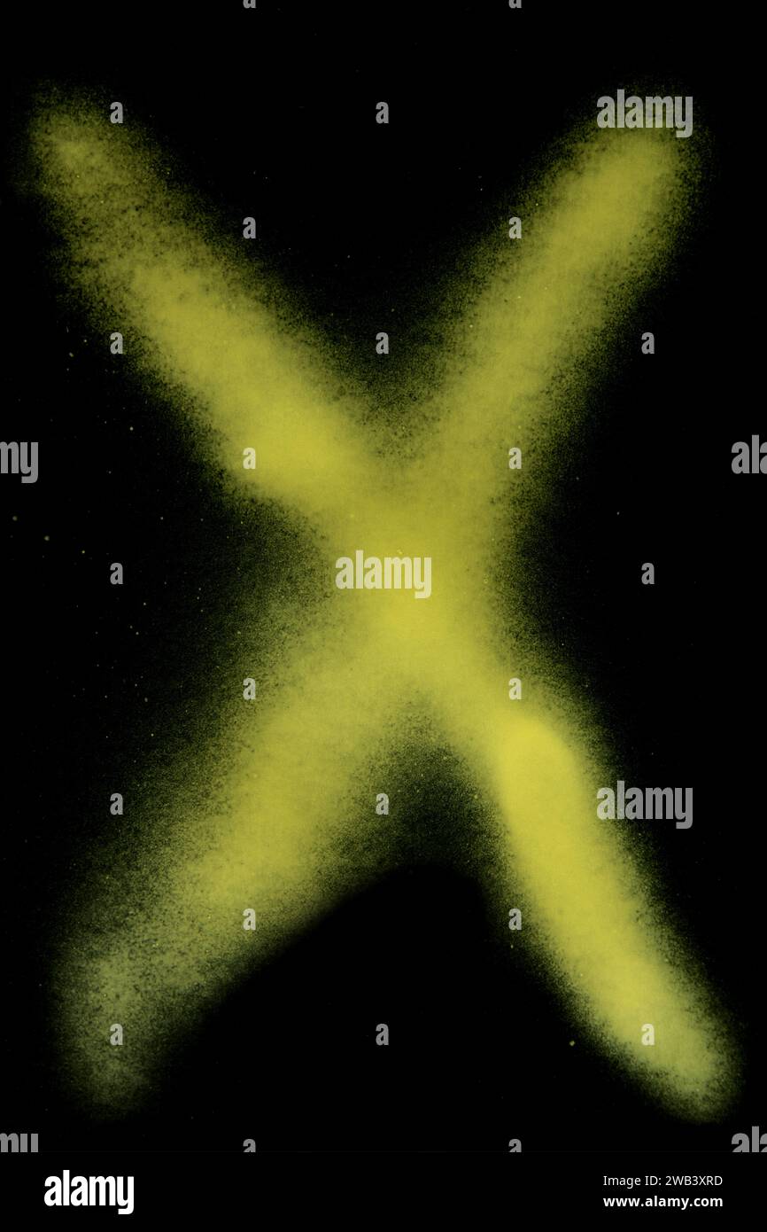 yellow x sign spray painted on black paper background Stock Photo Alamy