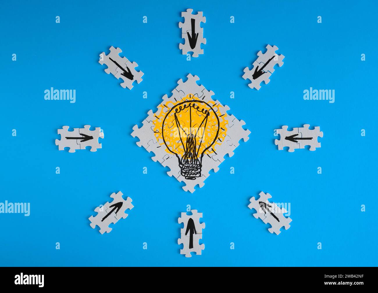 Business concept,collaboration,cooperation,teamwork, innovation,human resources,recruitment,team building with jigsaw puzzle pieces and lightbulb Stock Photo