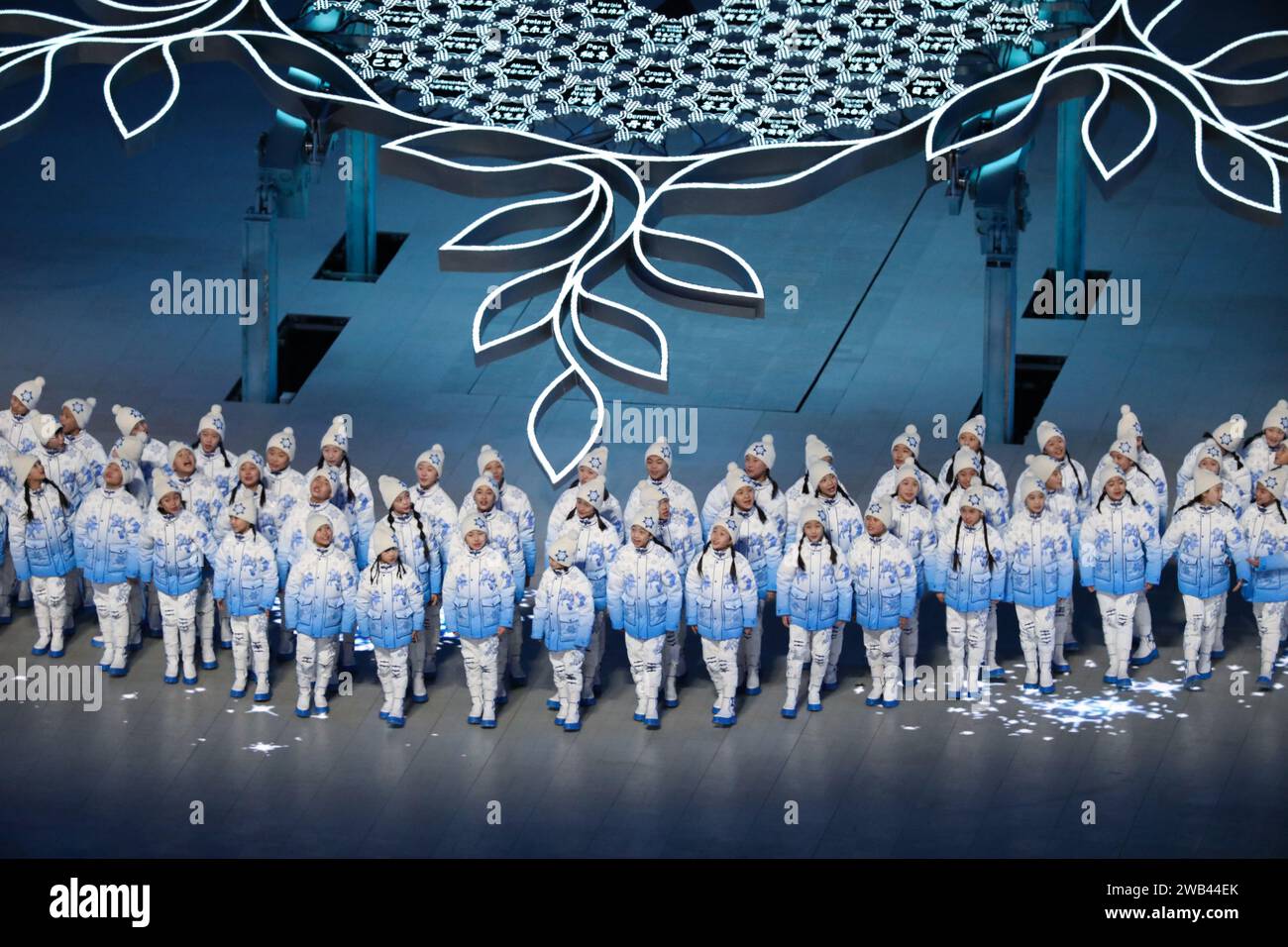 FEB 4, 2022 - Beijing, China: hundreds of children wander around the center stage singing the theme song of the ceremony titled “Snowflake”during the Stock Photo