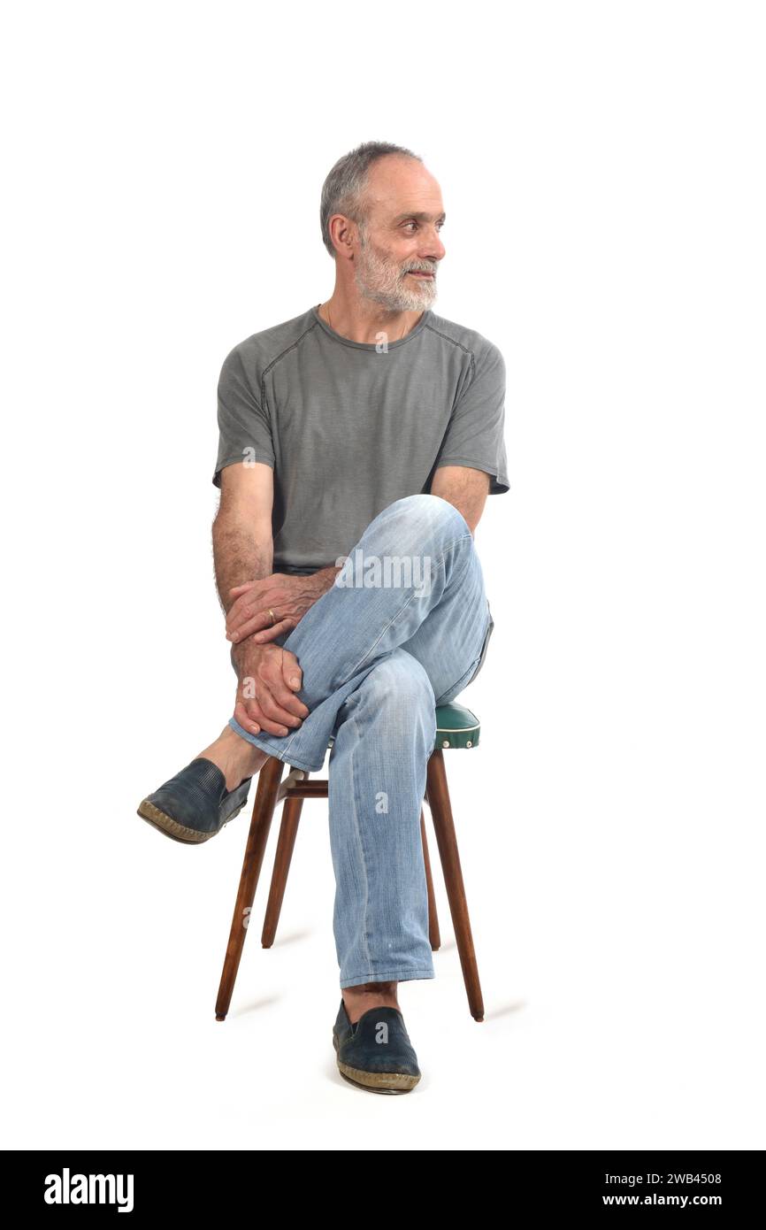 Man sitting cross legged on chair hires stock photography and images