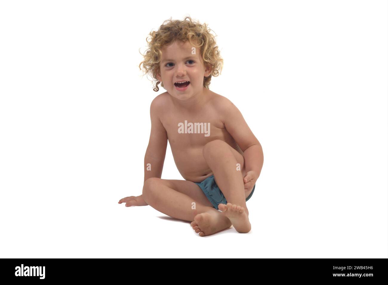 boy sitting o floor on white background Stock Photo