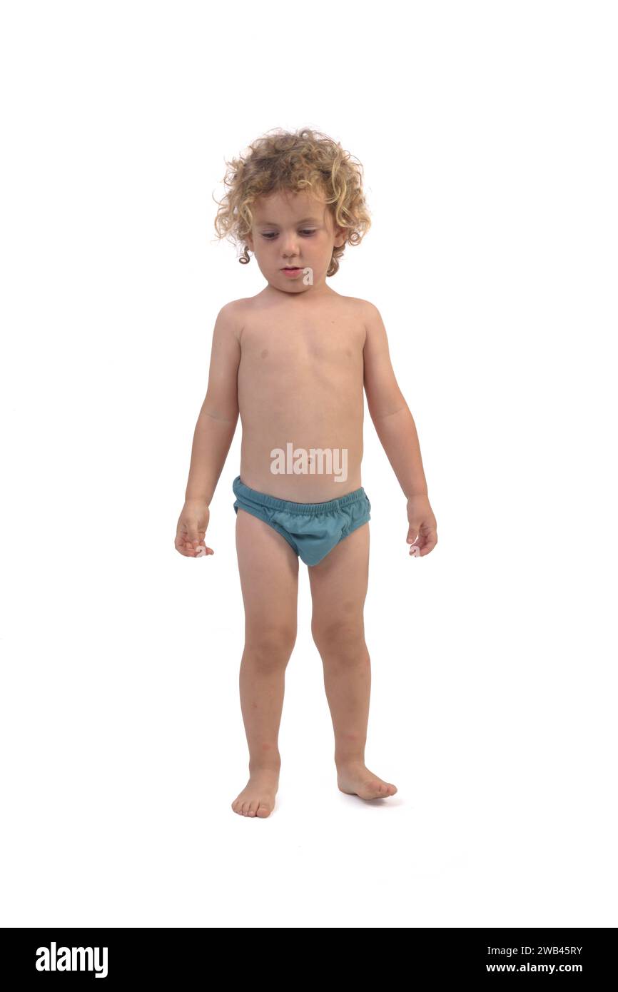 portrait of a boy in underpants look down on white background (3 year old) Stock Photo