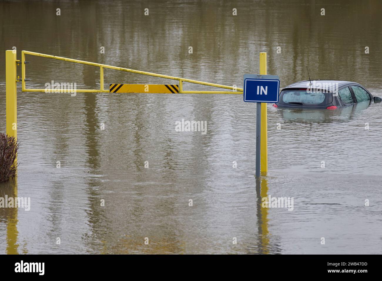 Abandoned Car Submerged In Flood Water In Parking Lot In Oxfordshire UK January 2024 Stock Photo