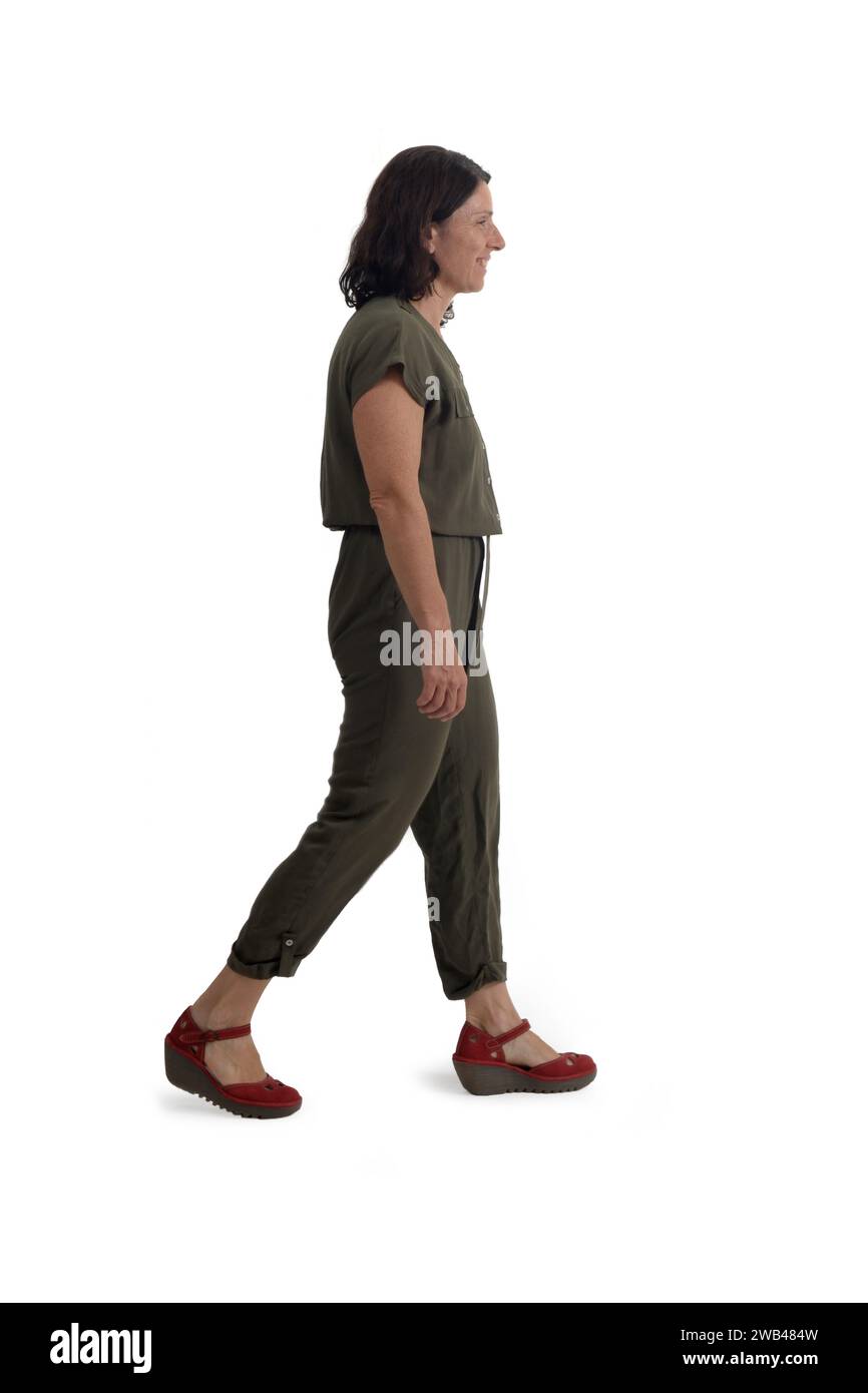 side view of a woman walking on white background Stock Photo