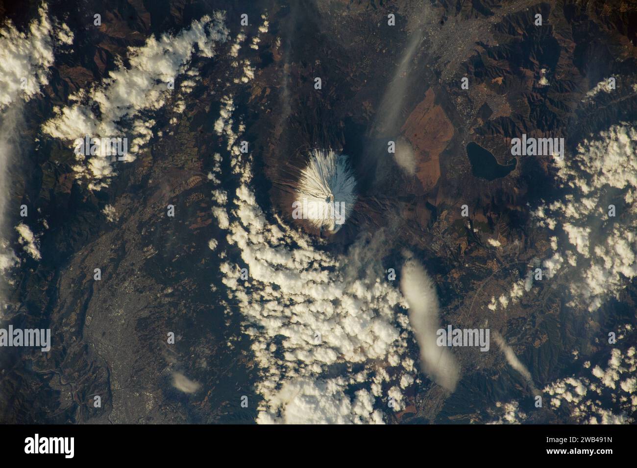 JAPAN - 14 December 2023 - The snow-capped Mount Fuji rises in Japan's Yamanashi and Shizuoka prefectures in this photograph from the International Sp Stock Photo