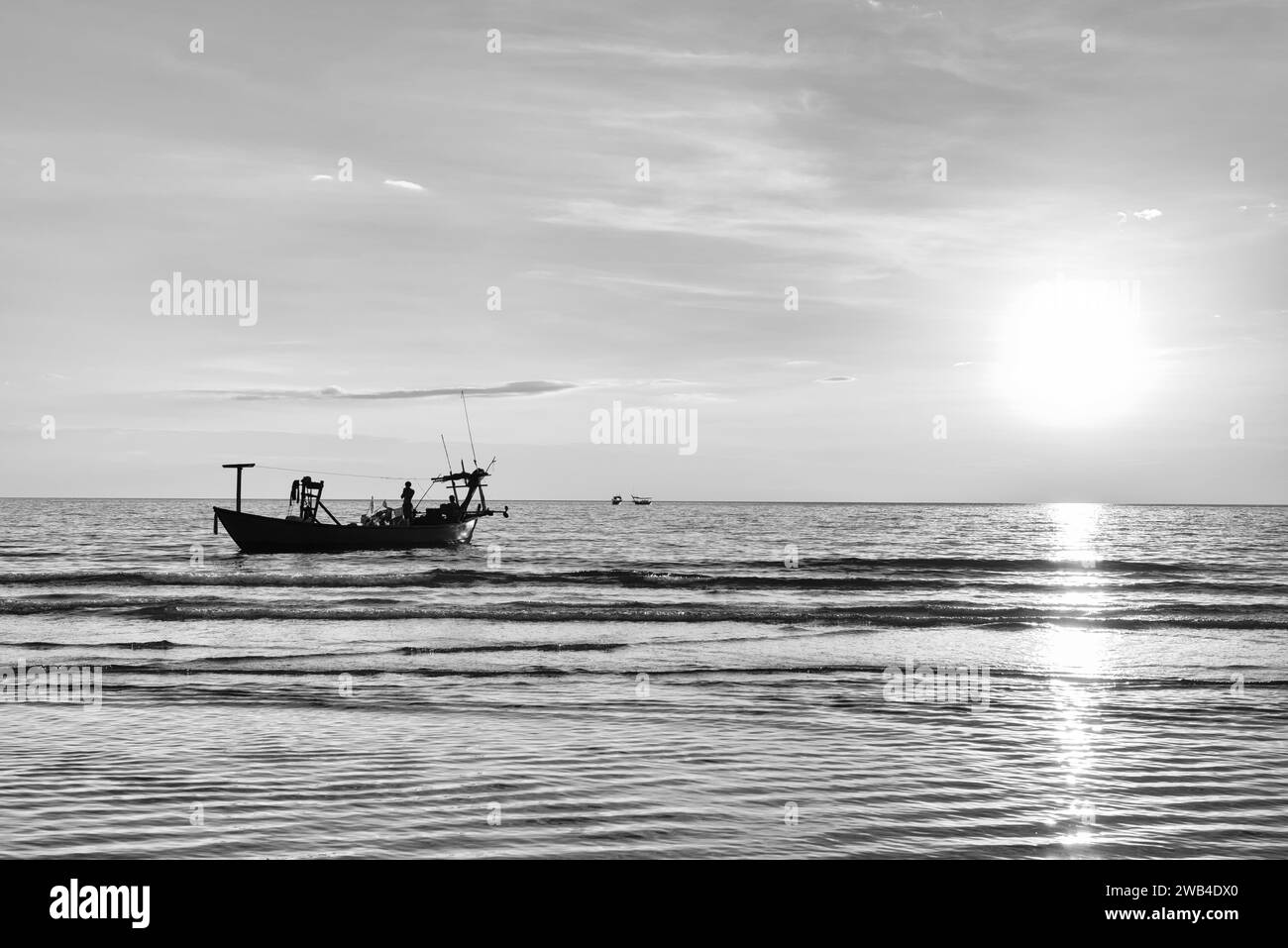 Fishing boat on the sea during sunset Stock Photo