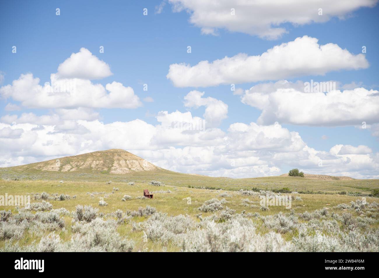 eroded prairie hills and grasslands, under a blue spring sky in Eastend Saskatchewan Stock Photo