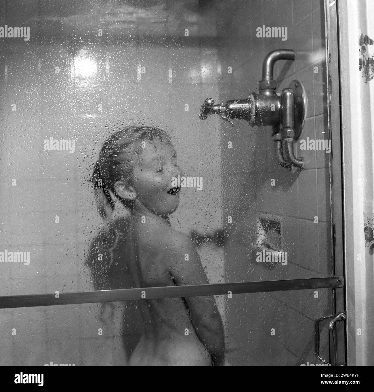 1991, historical, excited young girl enjoying the water from a power