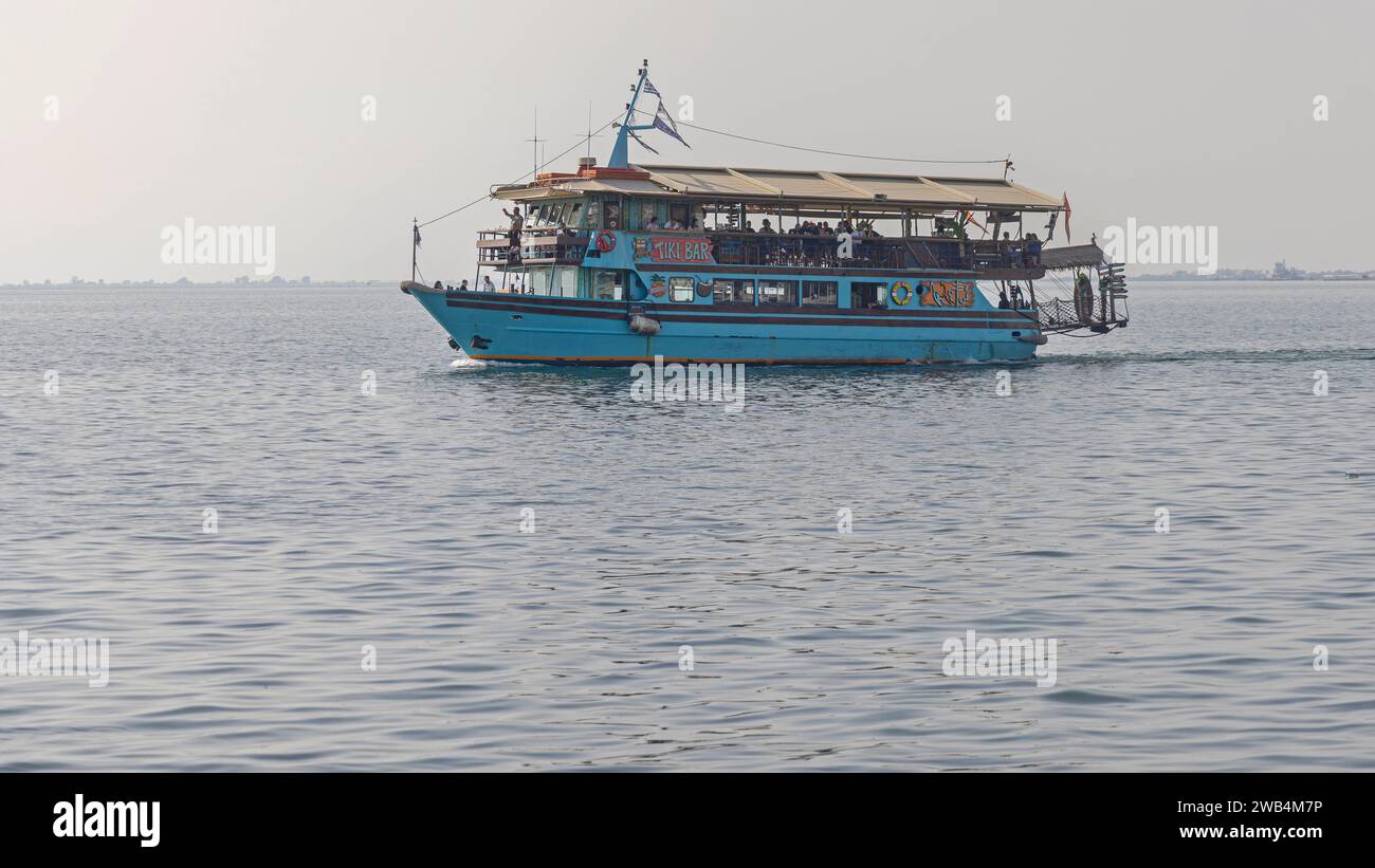 Thessaloniki, Greece - October 22, 2023: Party Ship Themed Tiki Bar Cruise Slowly at Aegean Sea Autumn Day. Stock Photo