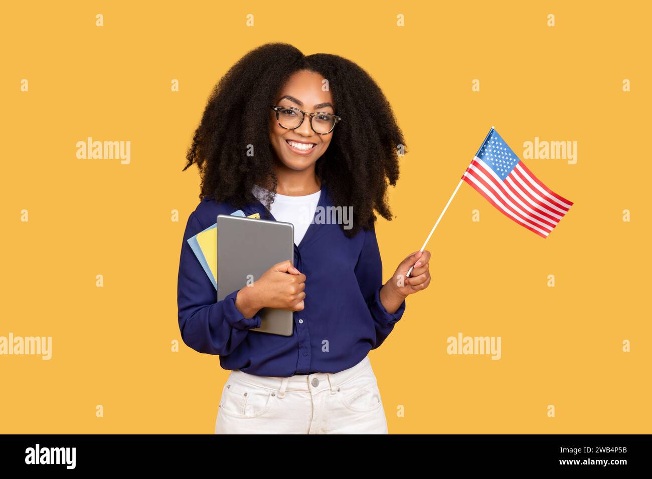 Smiling black lady student with backpack and bunch of books showing ...