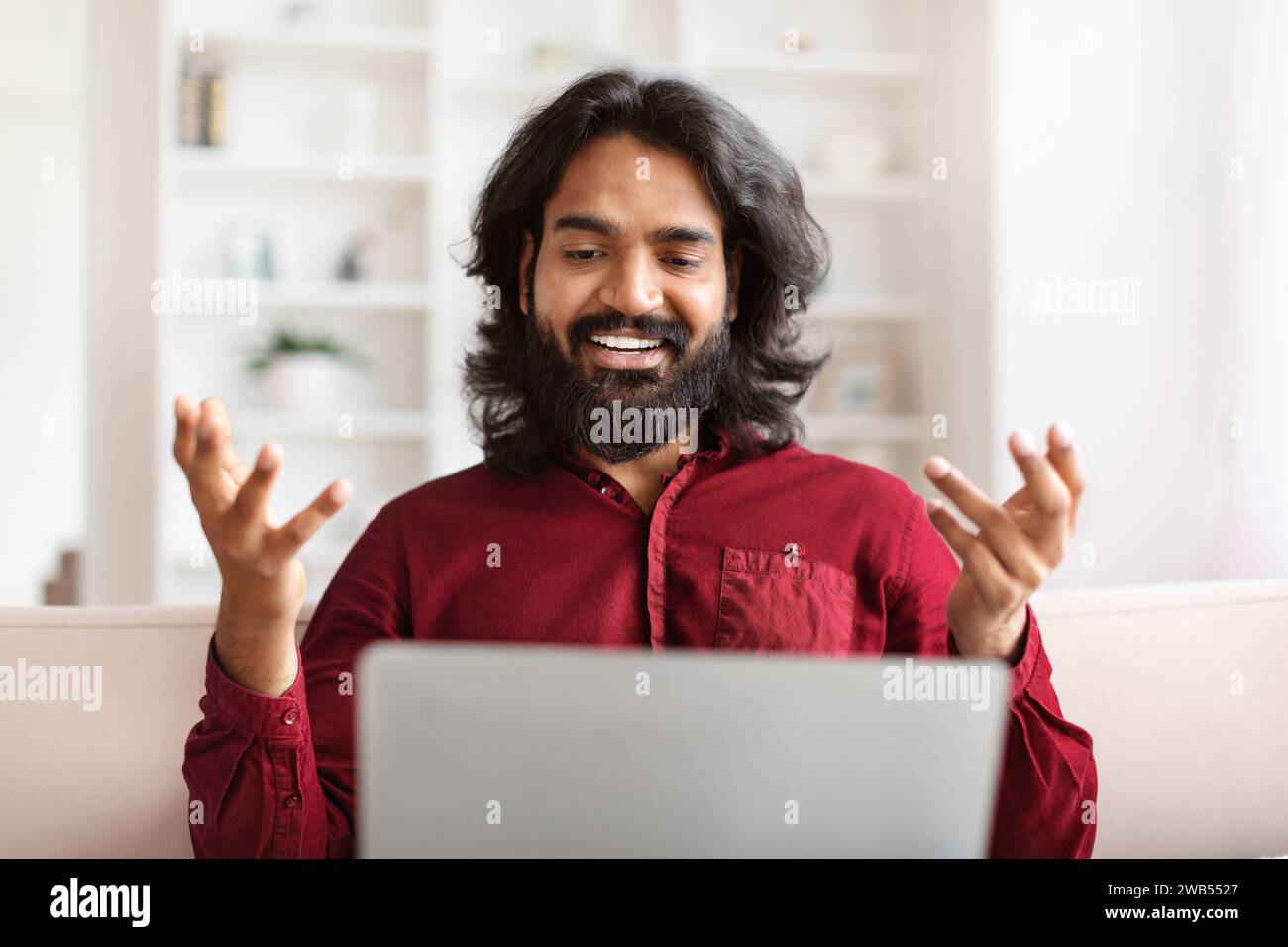 Portrait bearded young indian man have video call on laptop Stock Photo