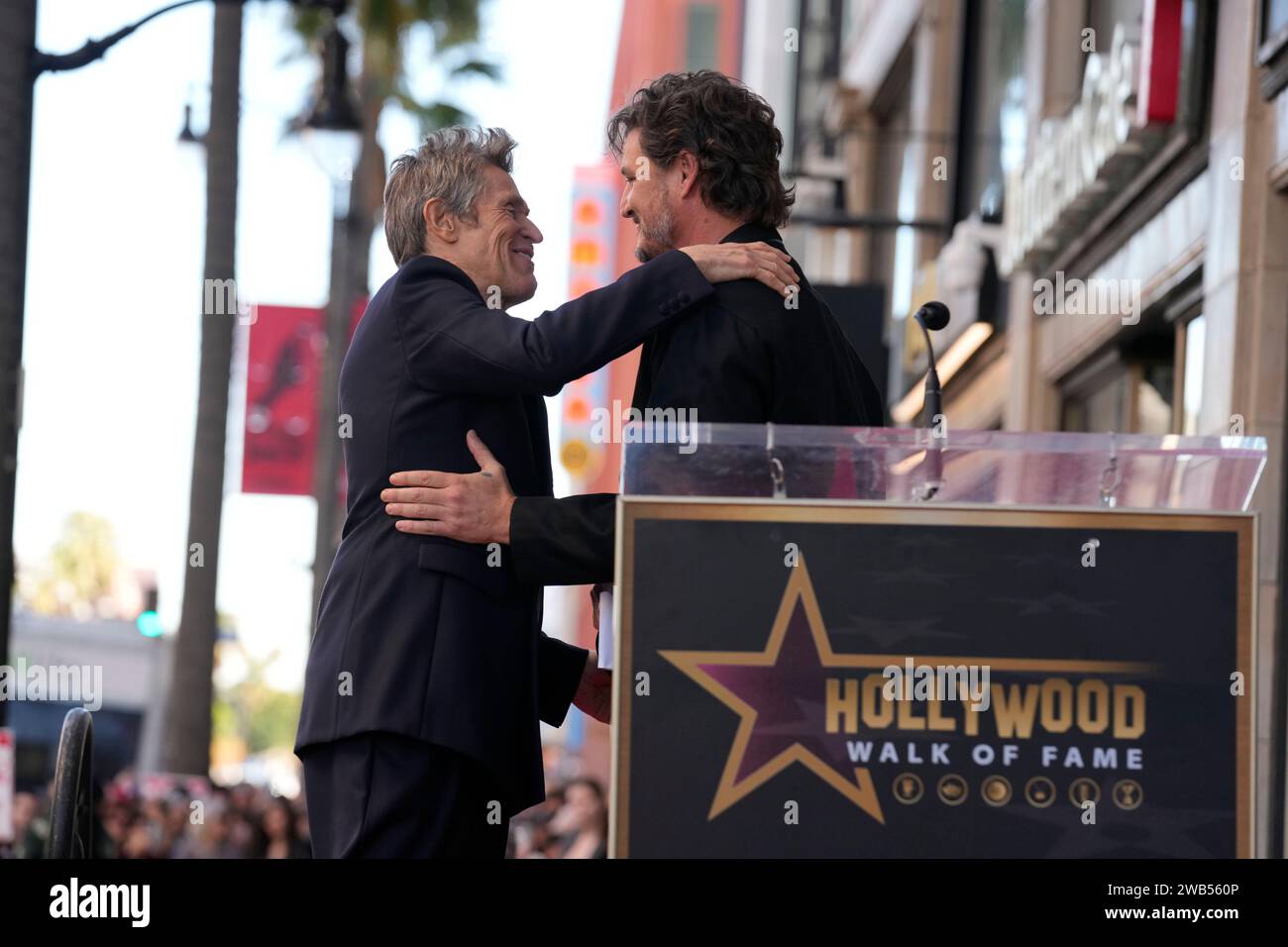 Pedro Pascal, right, embraces Willem Dafoe at a ceremony honoring Dafoe