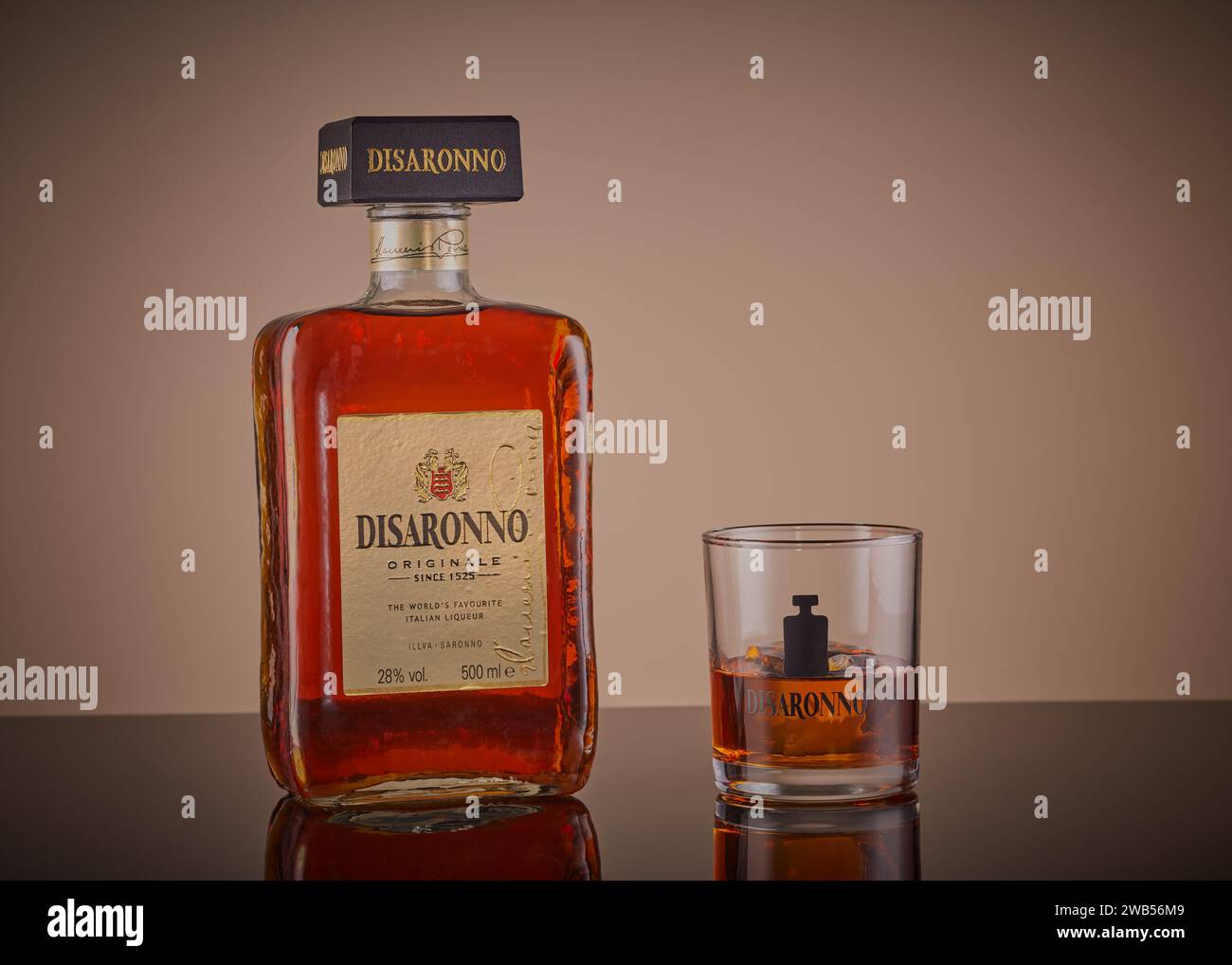 Mansfield,Nottingham,United Kingdom,6th January 2024:Studio product image of a bottle and glass of Disaronno,the company is owned by LLLva Saronno S.p. Stock Photo
