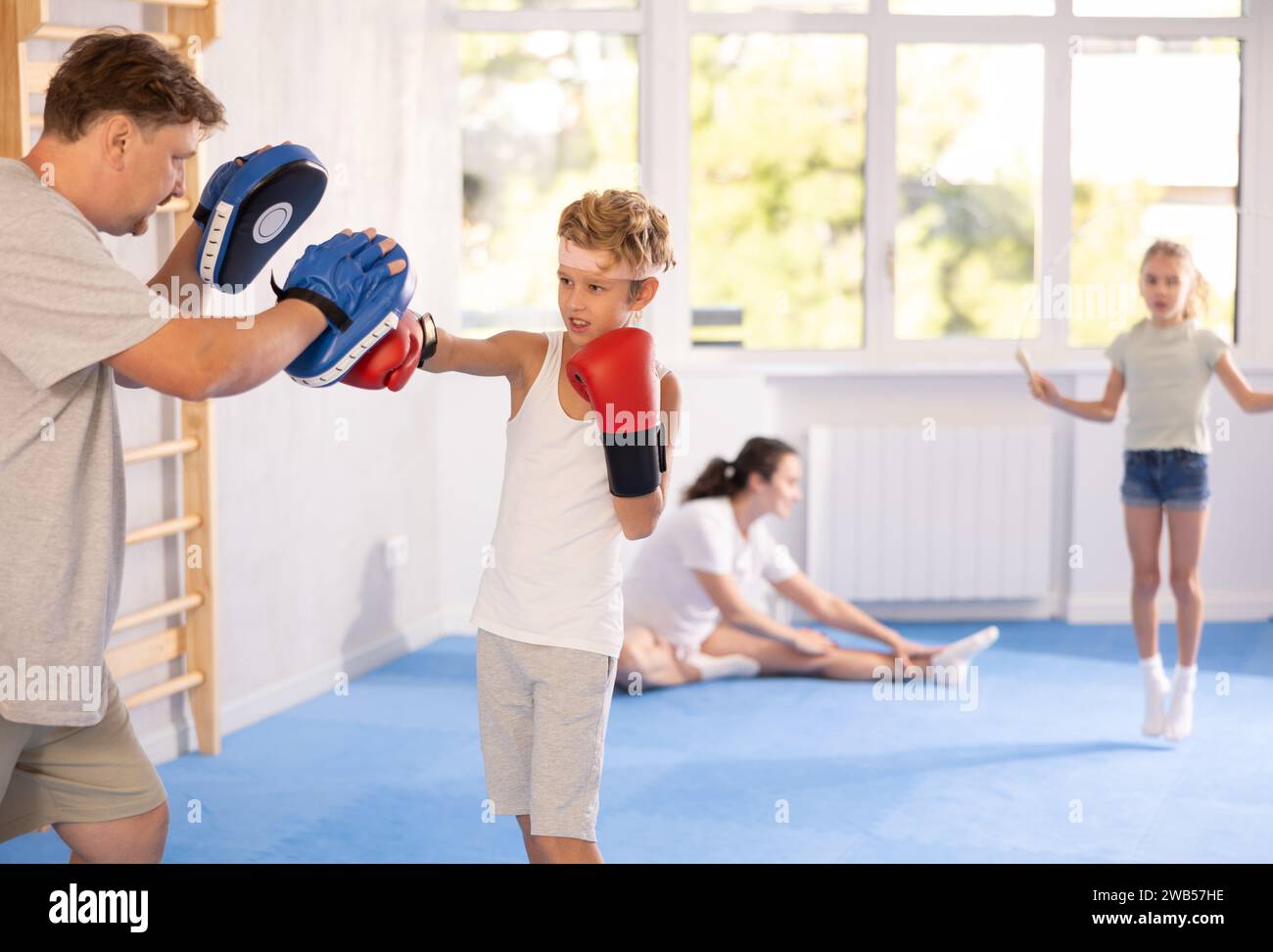 Boy hitting the focus mitts held by his boxing father Stock Photo Alamy