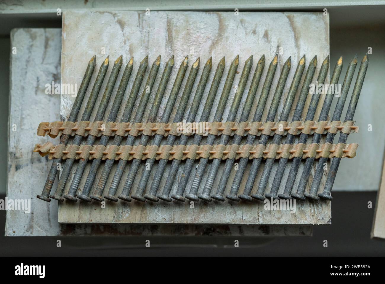 Nails for nail gun at job site Stock Photo - Alamy