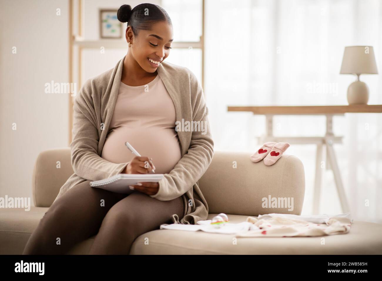 Pregnant black woman getting ready for the maternity hospital Stock Photo