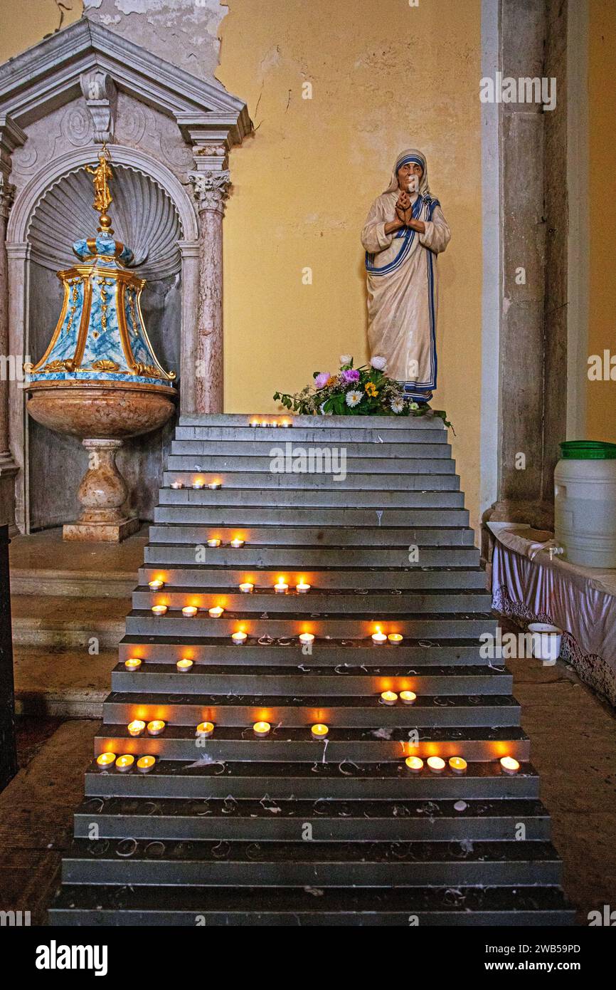 candles on the steps to the statue of the Mother of God Stock Photo