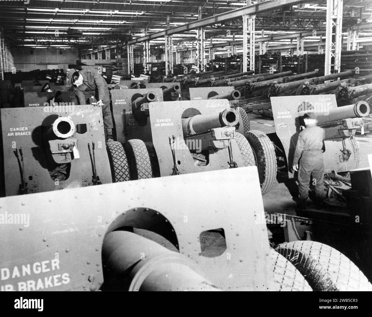 American-built 155 mm howitzers shipped to England as lend-lease reach an ordnance depot on their way to action. 1941 Stock Photo
