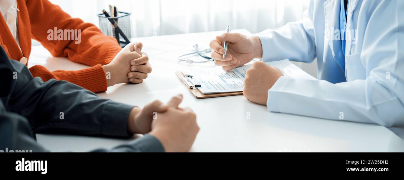 Couple attend fertility consultation with gynecologist at hospital as part family planning care