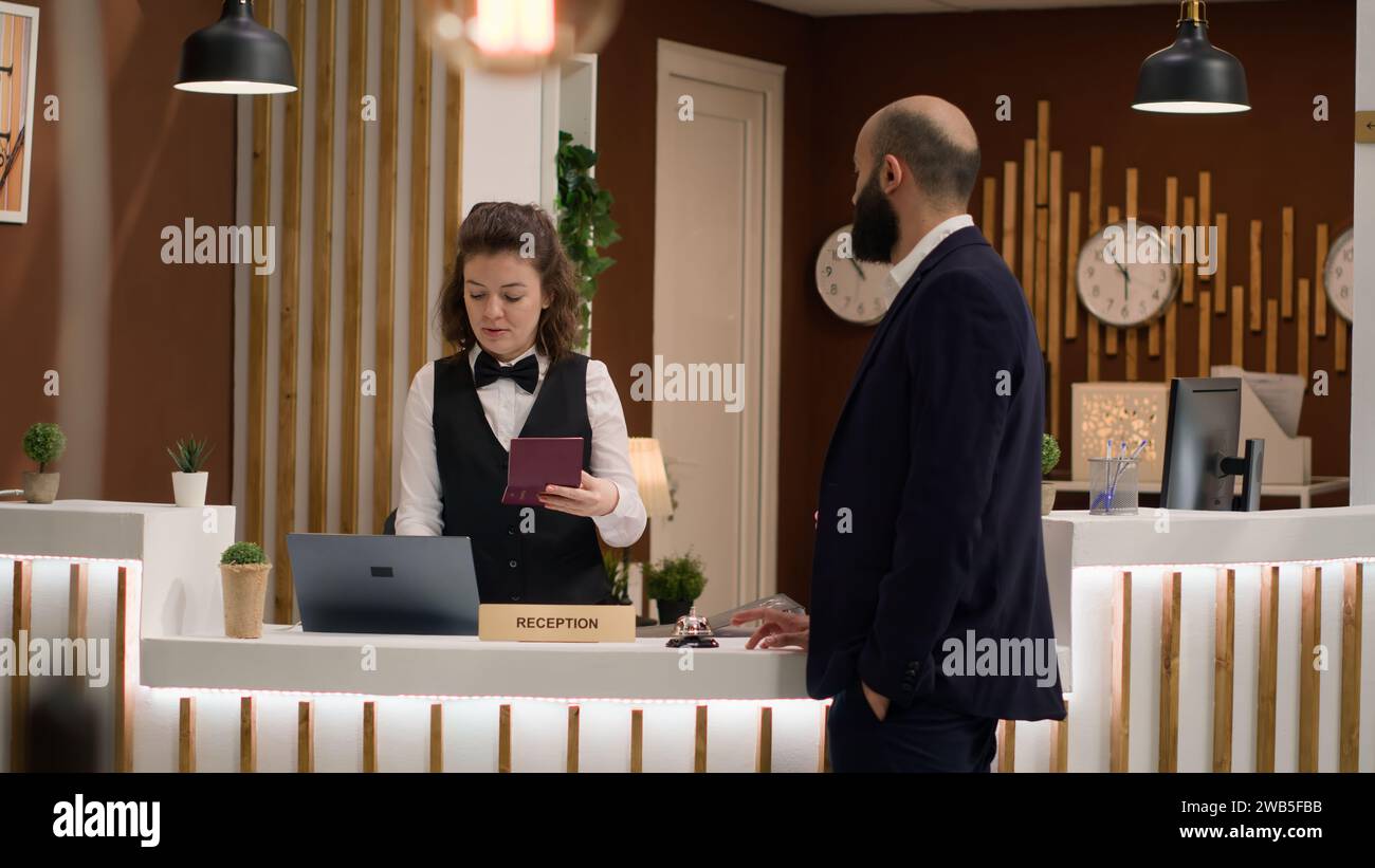 Hotel concierge verifying passport id for guest identification