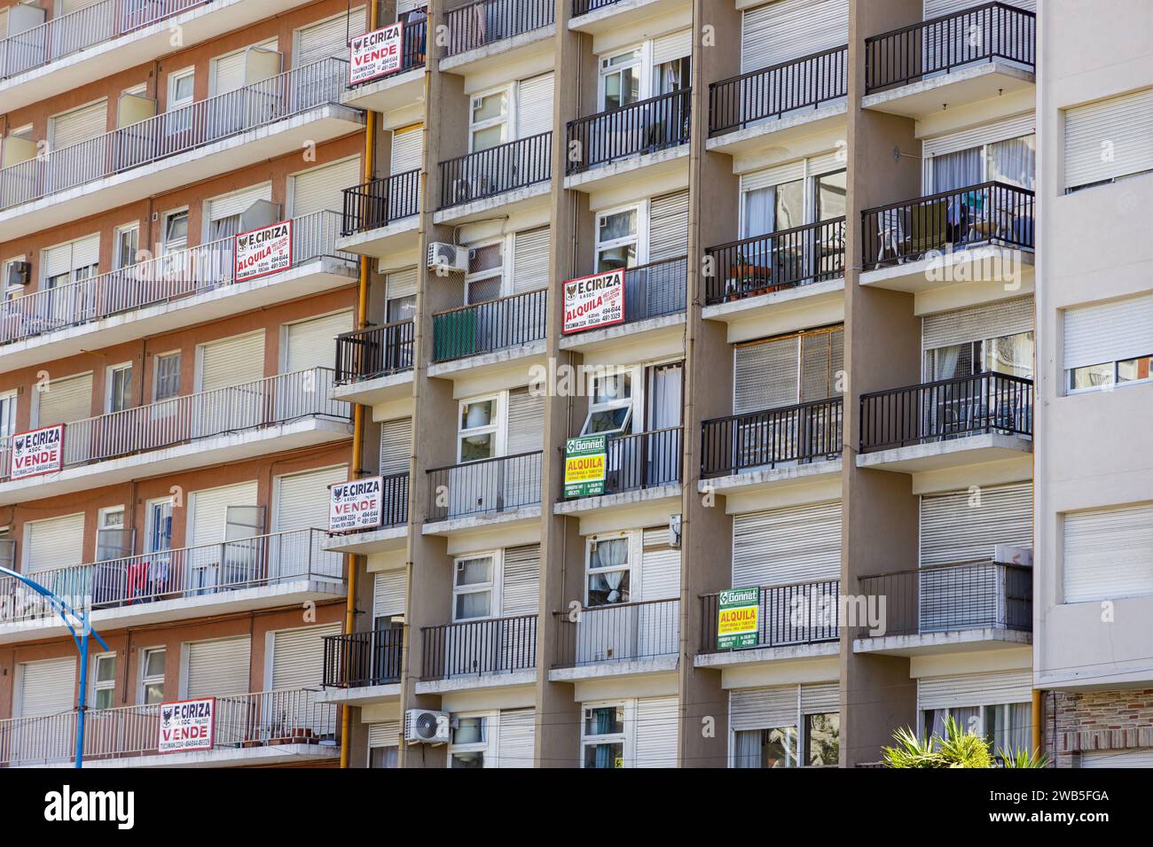 Mar del Plata, Argentina - December 30th, 2023: Apartment building with for sale and rent signs in Spanish. Stock Photo