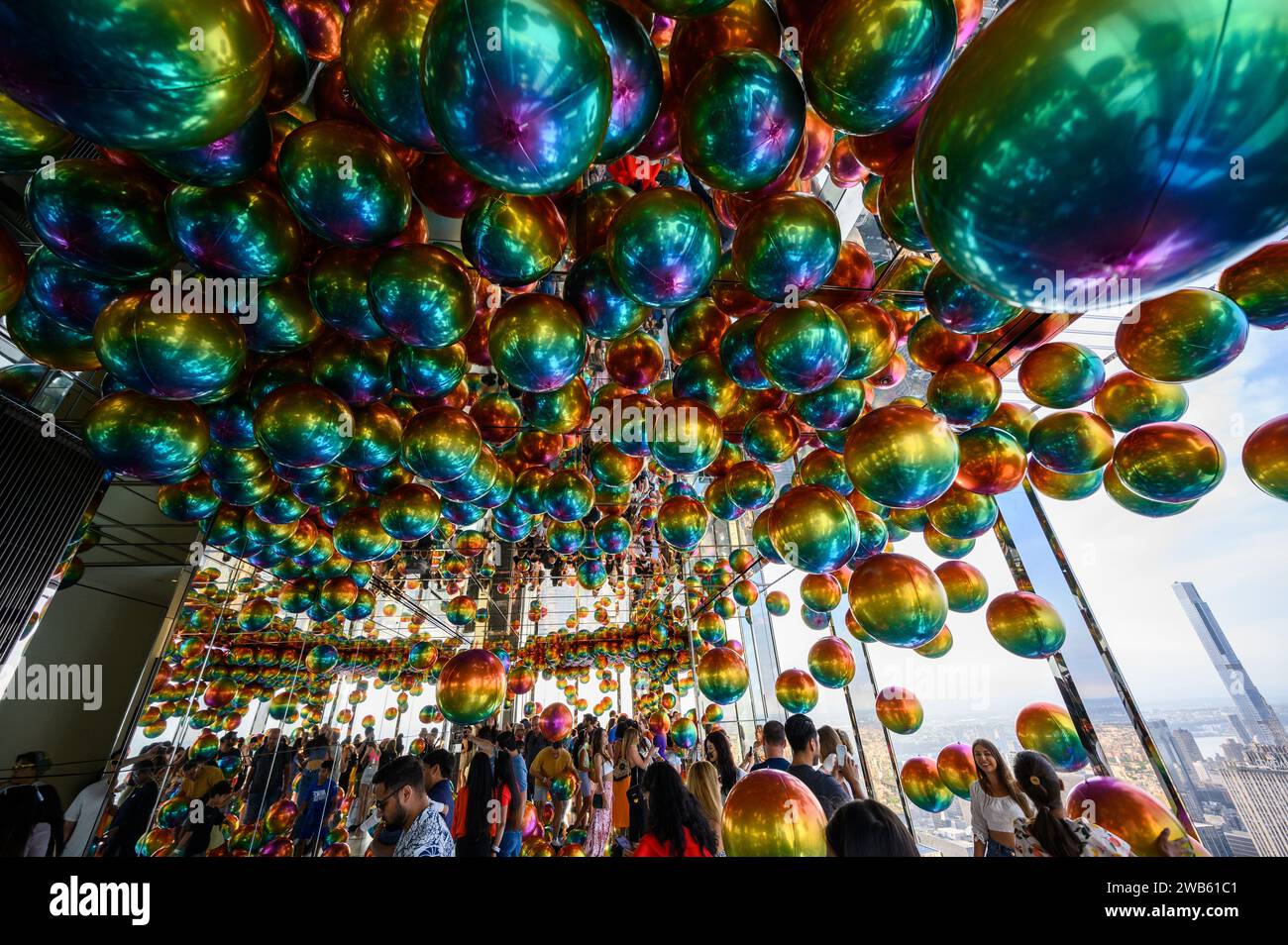 People playing and enjoying the colorful Pride Day balloons at the Summit One Vanderbilt observation deck in New York, U.S., in June 2022. Stock Photo