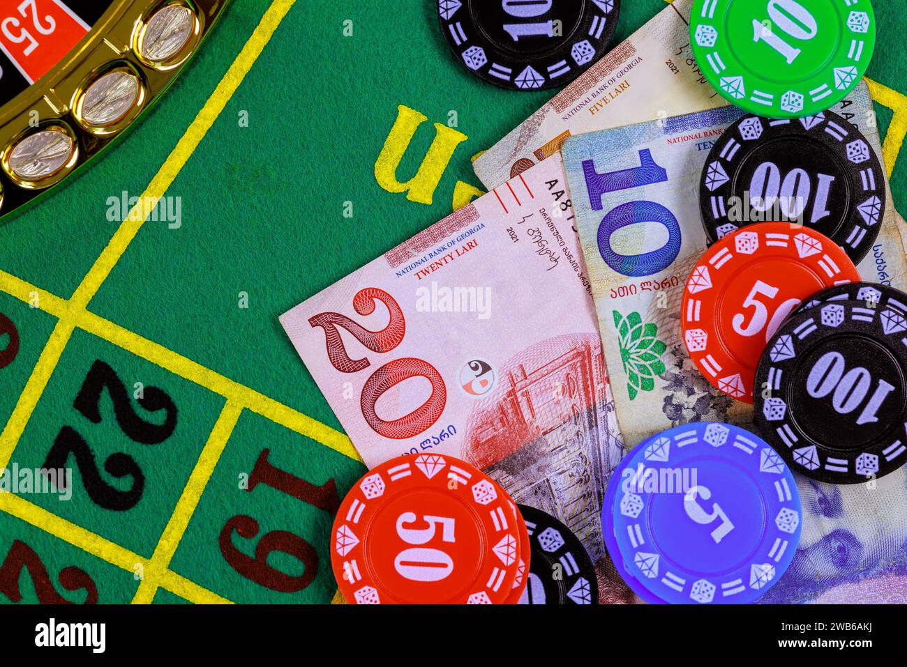Roulette casino table is with Georgian banknotes, lari, poker chips. Stock Photo