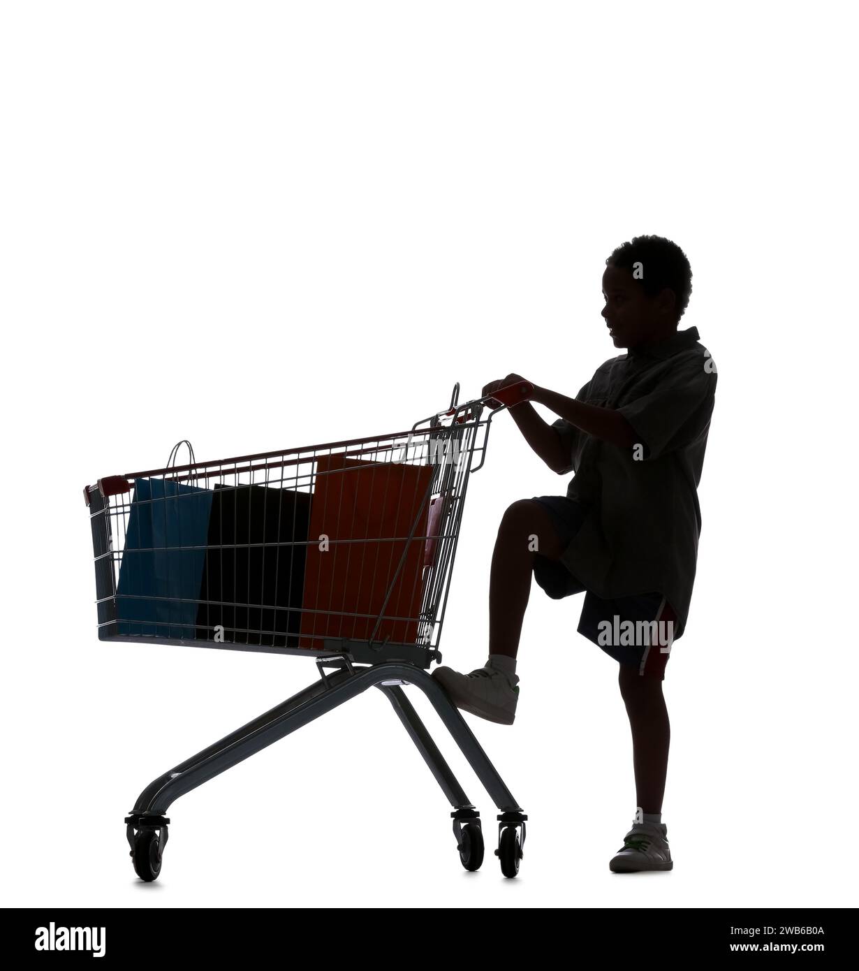 Silhouette of little boy with shopping cart on white background Stock Photo