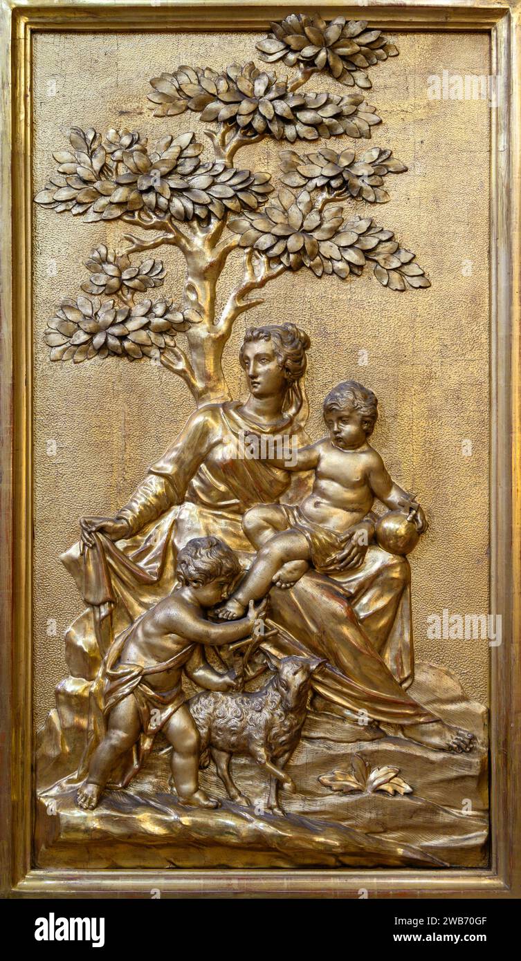 The Virgin Mary, Jesus and John the Baptist – a relief sculpture. Church of Saint Giles (Kirche St. Ägyd) in Gumpendorf, Vienna. Stock Photo