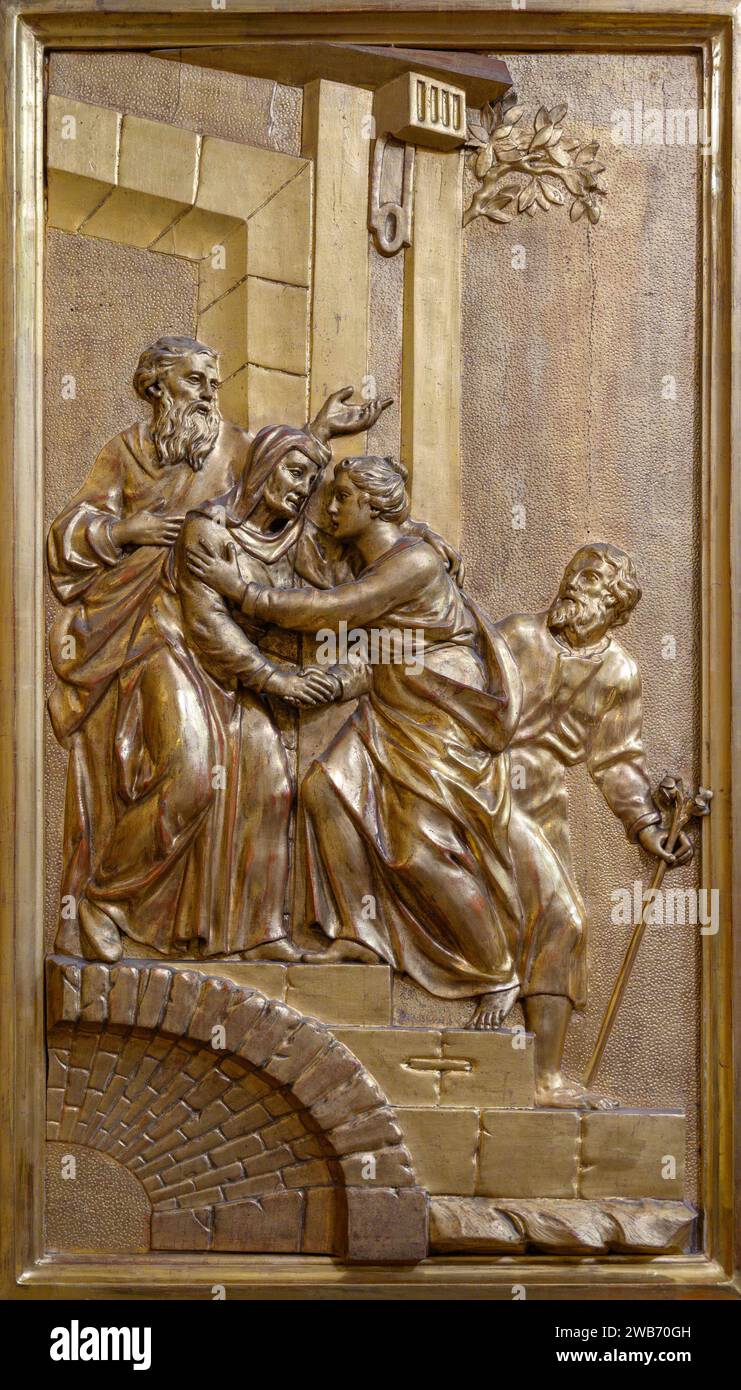 The Visitation (the Virgin Mary visits her relative Elizabeth) – a relief sculpture. Church of Saint Giles (Kirche St. Ägyd) in Gumpendorf, Vienna. Stock Photo