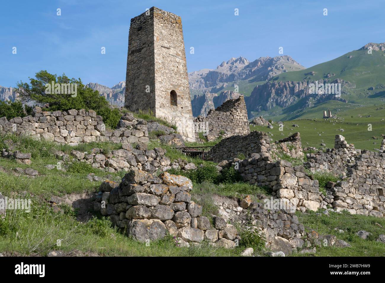 Ancient defensive tower in the North Caucasus mountains on a sunny June morning. Tsmiti, North Ossetia-Alania, Russian Federation Stock Photo
