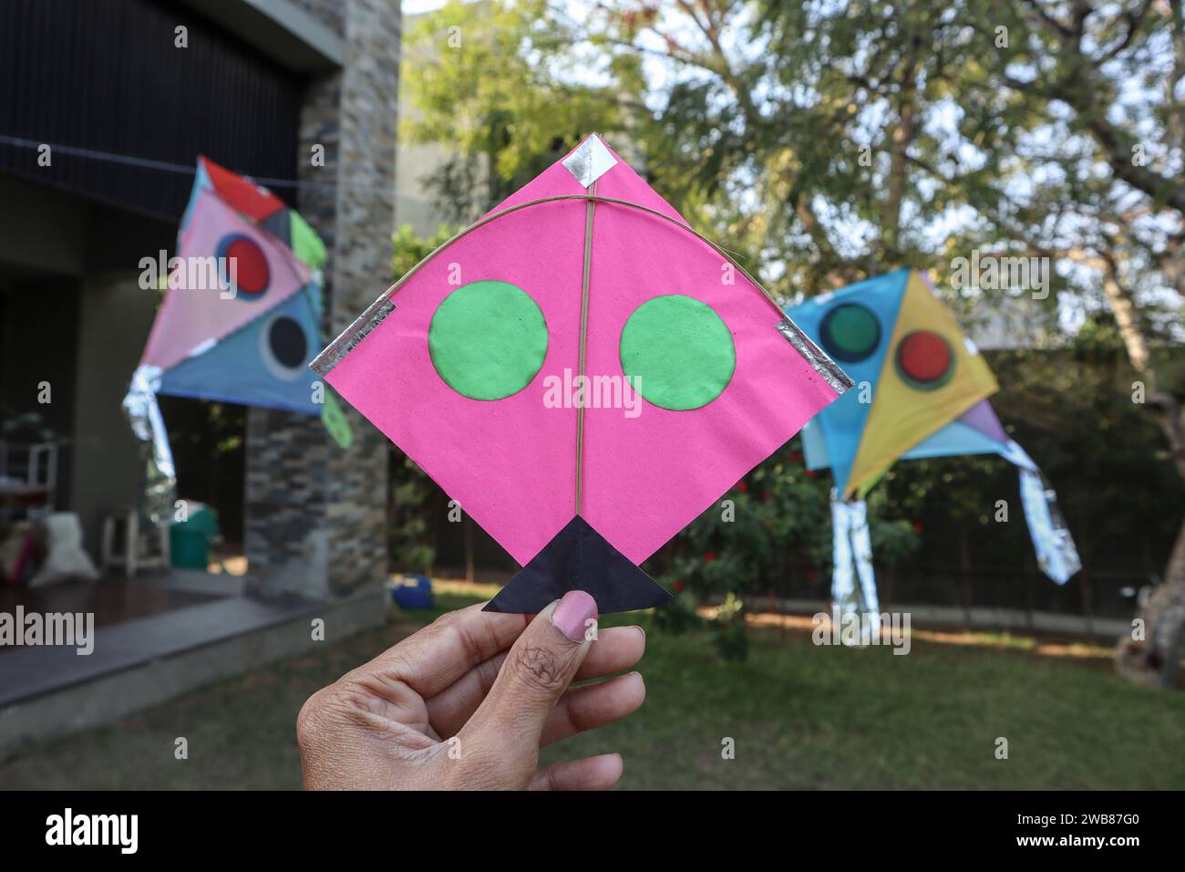 Small Pink kite in hands. Kite flying during kite festival. Happy makar
