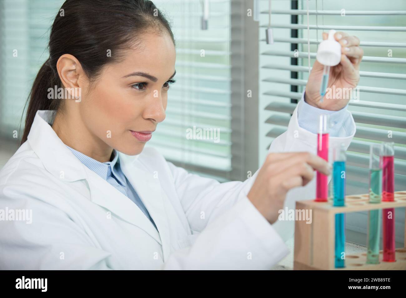 Scientist adding solution test tube hi-res stock photography and images ...