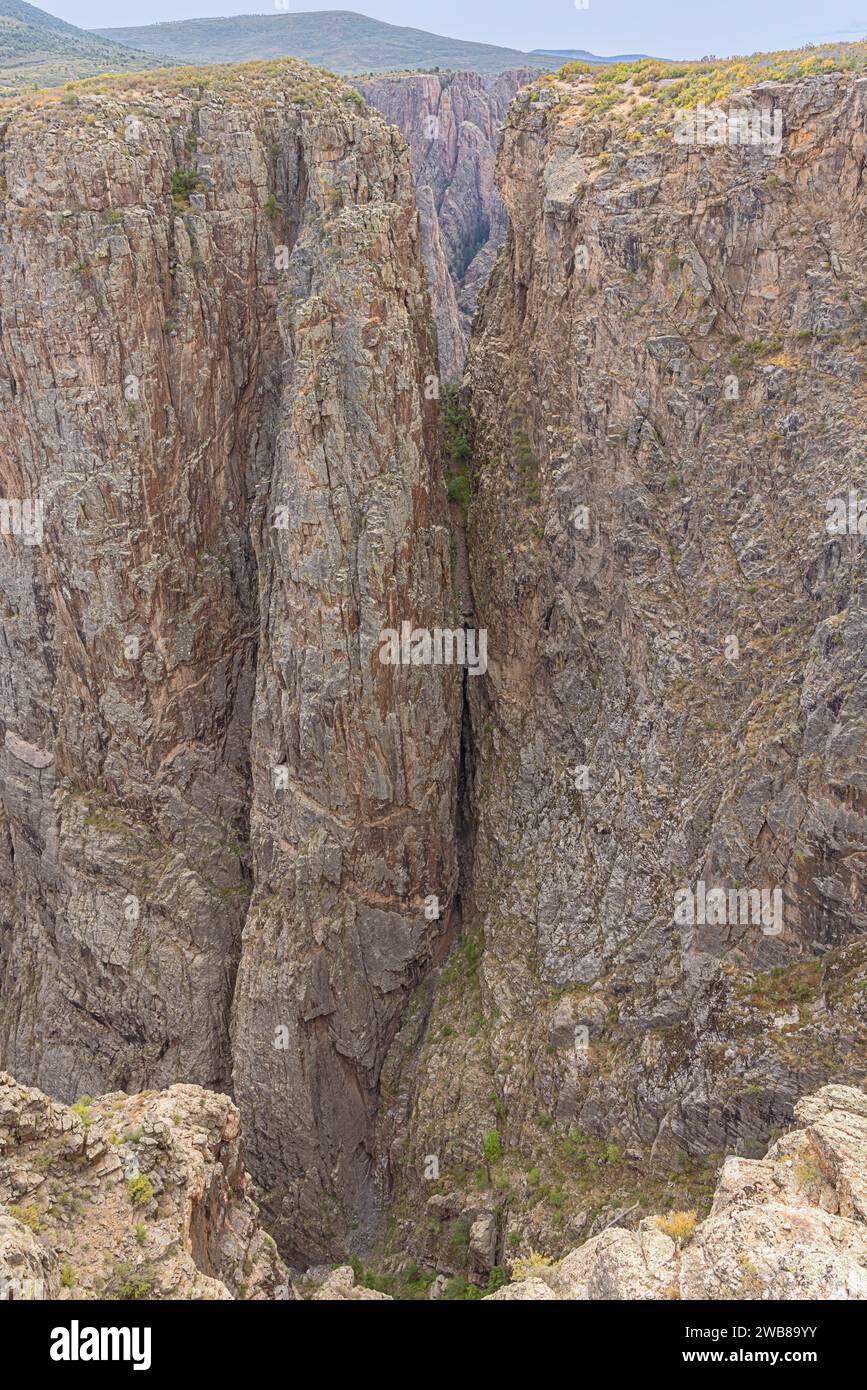 Deep gorges in the north rim of the Black Canyon of the Gunnison at Rock Point on the south rim Stock Photo