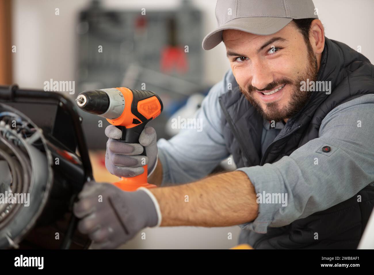 car body repair happy young mechanic in garage Stock Photo