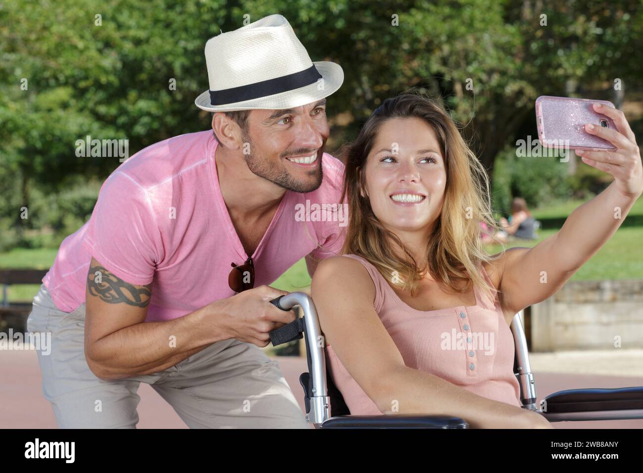 woman in wheelchair taking a selfie with boyfriend Stock Photo - Alamy