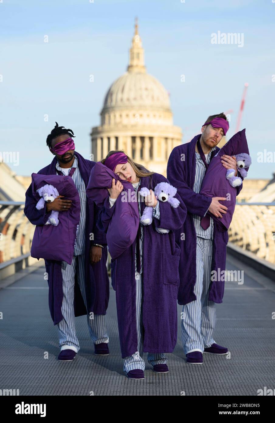 EDITORIAL USE ONLY 'Sleep deprived commuters' in pyjamas and dressing