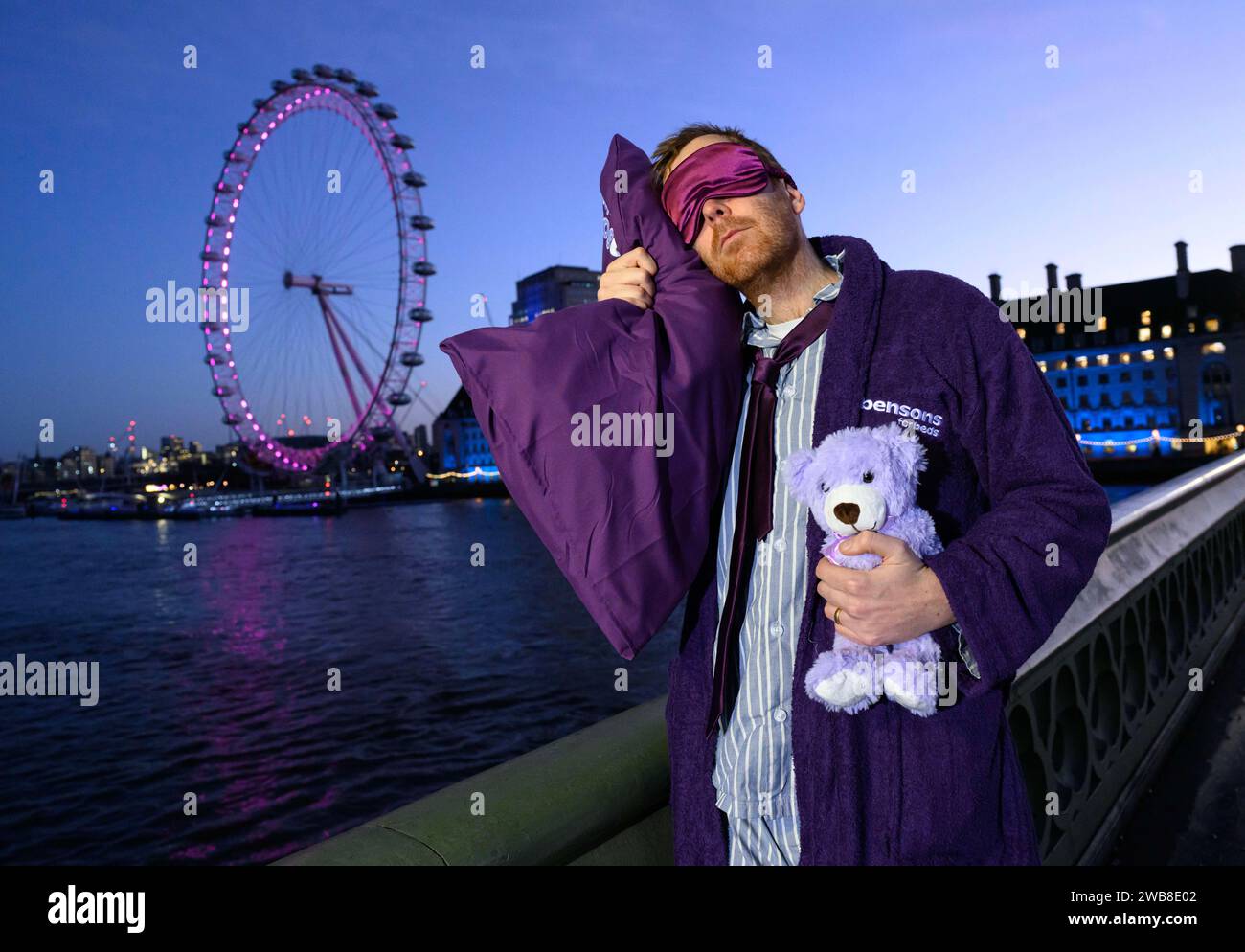 EDITORIAL USE ONLY 'Sleep deprived commuters' in pyjamas and dressing