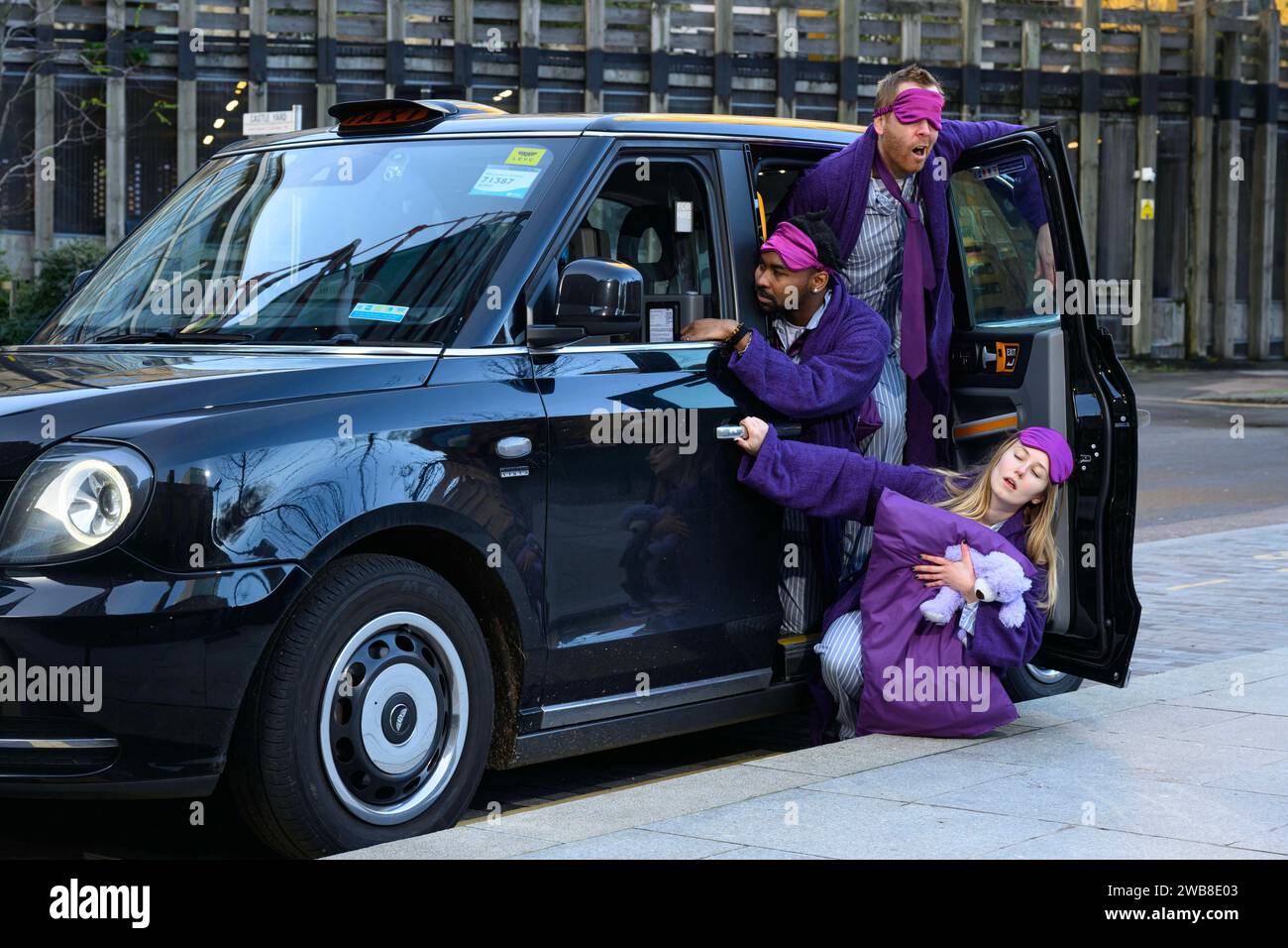 EDITORIAL USE ONLY 'Sleep deprived commuters' in pyjamas and dressing