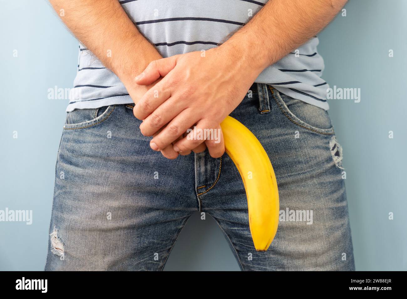 banana out of mens jeans like men penis. potency concept Stock Photo