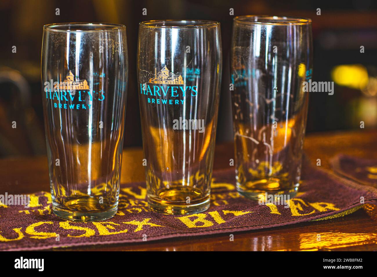 Empty pint glasses standing on a beer matt in the pub. Stock Photo